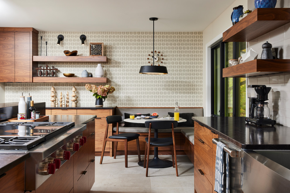 Inspiration for a large transitional u-shaped porcelain tile and gray floor enclosed kitchen remodel in Minneapolis with a farmhouse sink, flat-panel cabinets, medium tone wood cabinets, granite countertops, gray backsplash, ceramic backsplash, stainless steel appliances, an island and black countertops