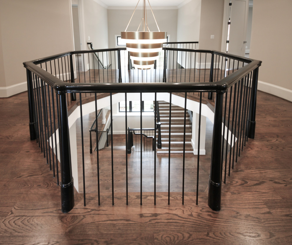 This is an example of an expansive bohemian wood u-shaped mixed railing staircase in DC Metro with wood risers.