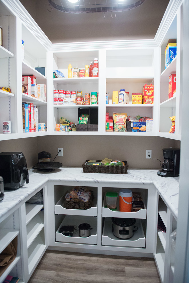 Inspiration for a large transitional u-shaped medium tone wood floor enclosed kitchen remodel in Other with open cabinets, white cabinets, laminate countertops and white countertops