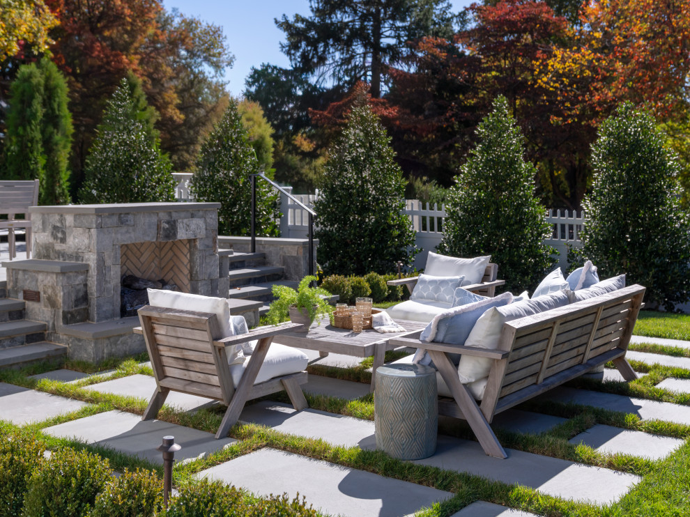 Patio - mid-sized traditional backyard stone patio idea in DC Metro with a fireplace