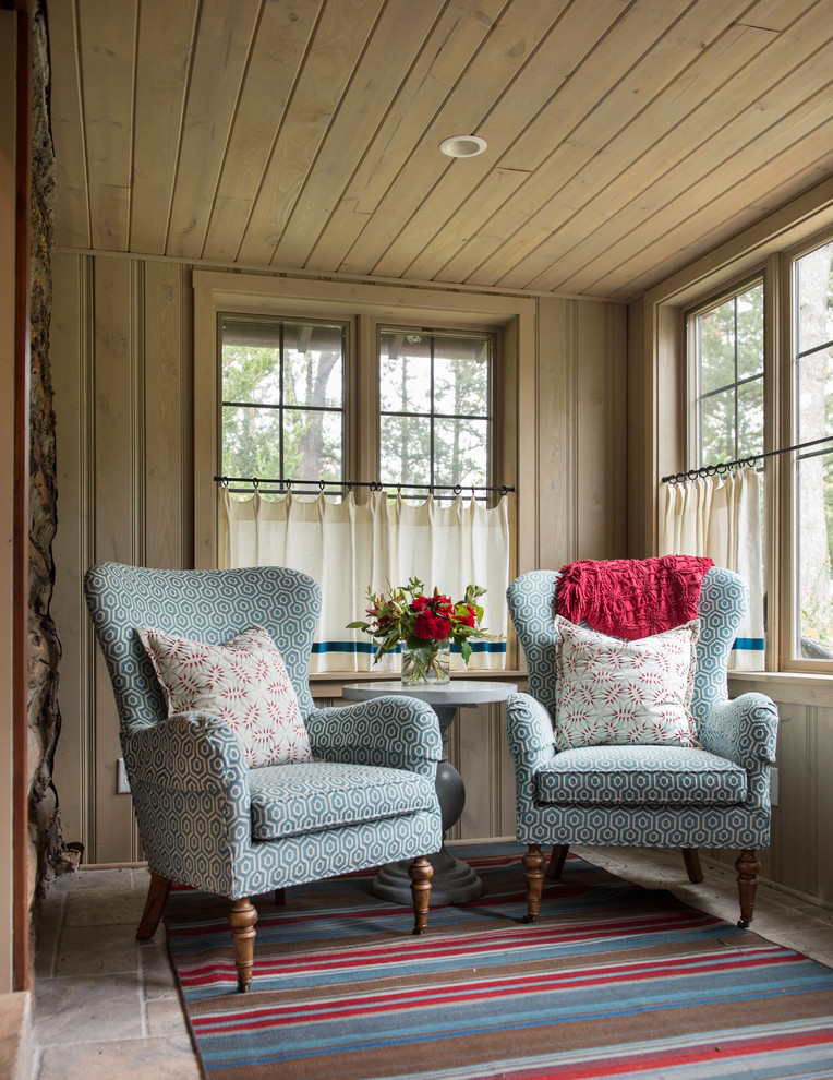 Inspiration for a country screened-in verandah in Kansas City with tile and a roof extension.