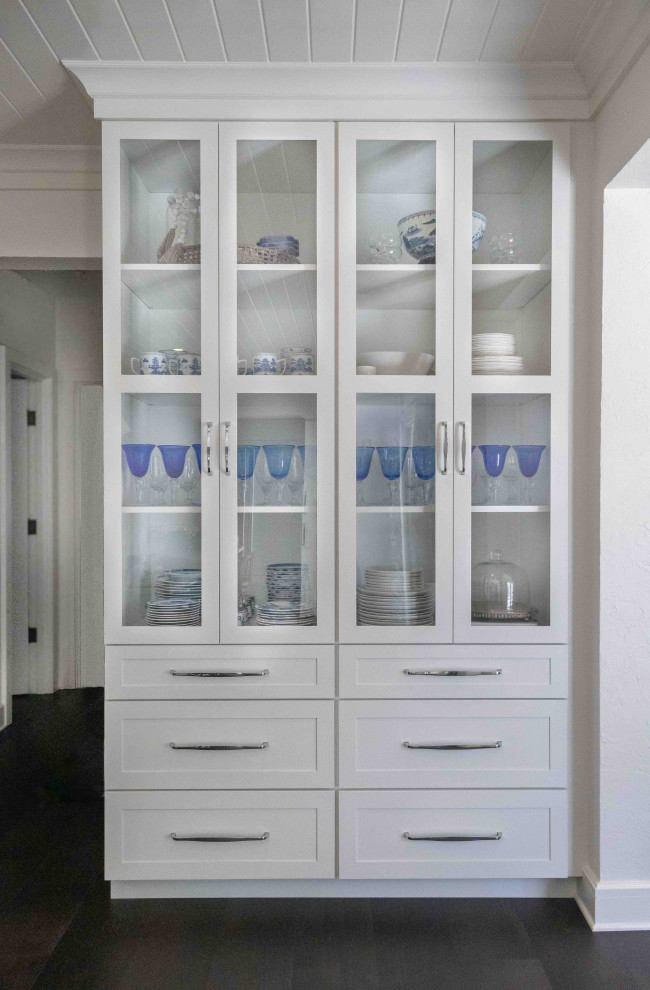 This is an example of a large beach style single-wall eat-in kitchen in Jacksonville with a farmhouse sink, flat-panel cabinets, white cabinets, quartzite benchtops, blue splashback, ceramic splashback, stainless steel appliances, dark hardwood floors, with island, brown floor, white benchtop and timber.
