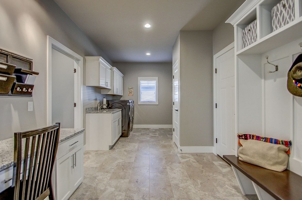 Example of a large transitional utility room design with an undermount sink, granite countertops, gray walls, a side-by-side washer/dryer, shaker cabinets and white cabinets
