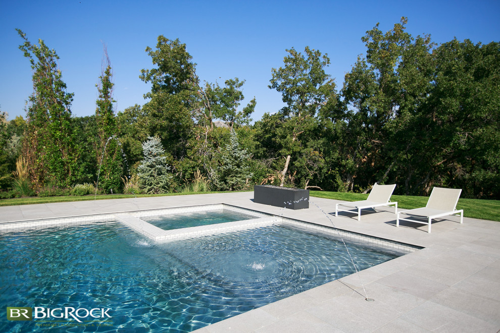 Large trendy backyard concrete and rectangular lap hot tub photo in Salt Lake City