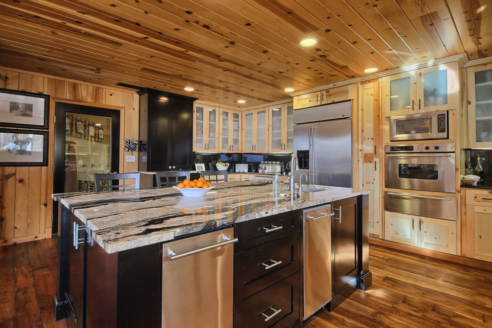 Photo of a large country u-shaped eat-in kitchen in Other with an undermount sink, glass-front cabinets, light wood cabinets, stainless steel appliances, medium hardwood floors, with island and black splashback.