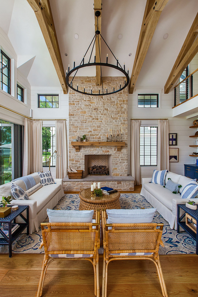 Family room - large coastal medium tone wood floor and exposed beam family room idea in Detroit