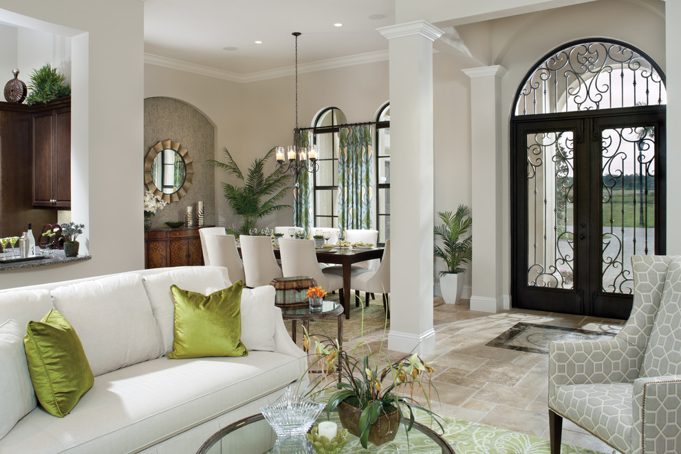 Photo of a mediterranean entryway in Tampa with beige walls and beige floor.