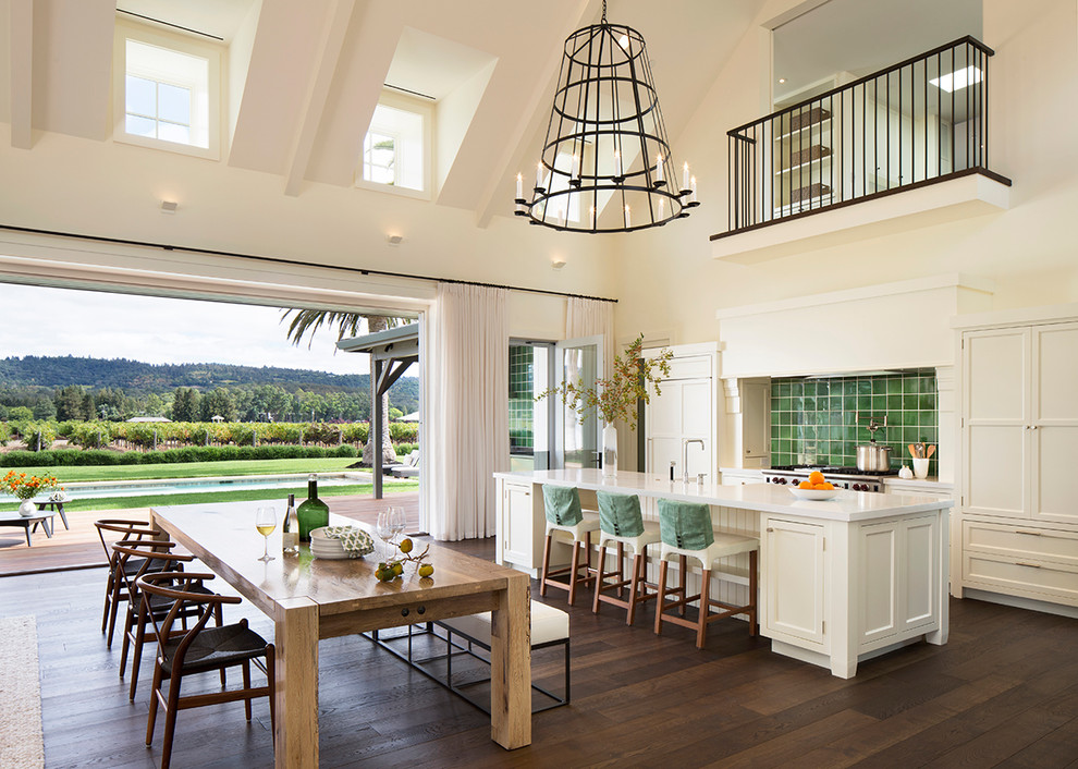 Open concept kitchen - contemporary dark wood floor open concept kitchen idea in San Francisco with shaker cabinets, white cabinets, green backsplash, stainless steel appliances and an island