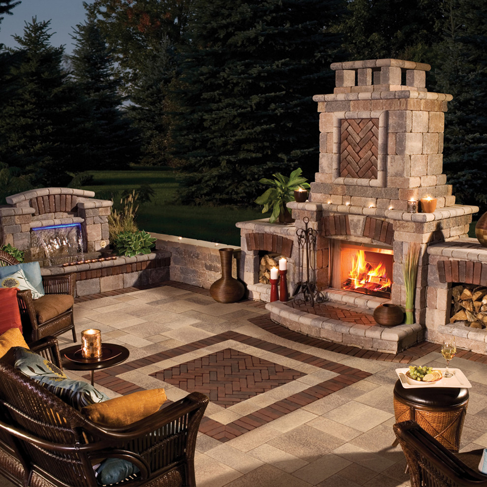 This is an example of a mid-sized mediterranean backyard patio in Other with a fire feature, concrete pavers and no cover.