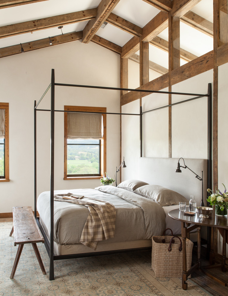 Country bedroom in San Francisco with white walls and dark hardwood floors.