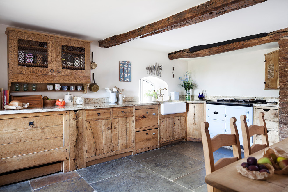 Inspiration for a large country u-shaped eat-in kitchen in Manchester with a farmhouse sink, flat-panel cabinets, medium wood cabinets, granite benchtops, panelled appliances and no island.