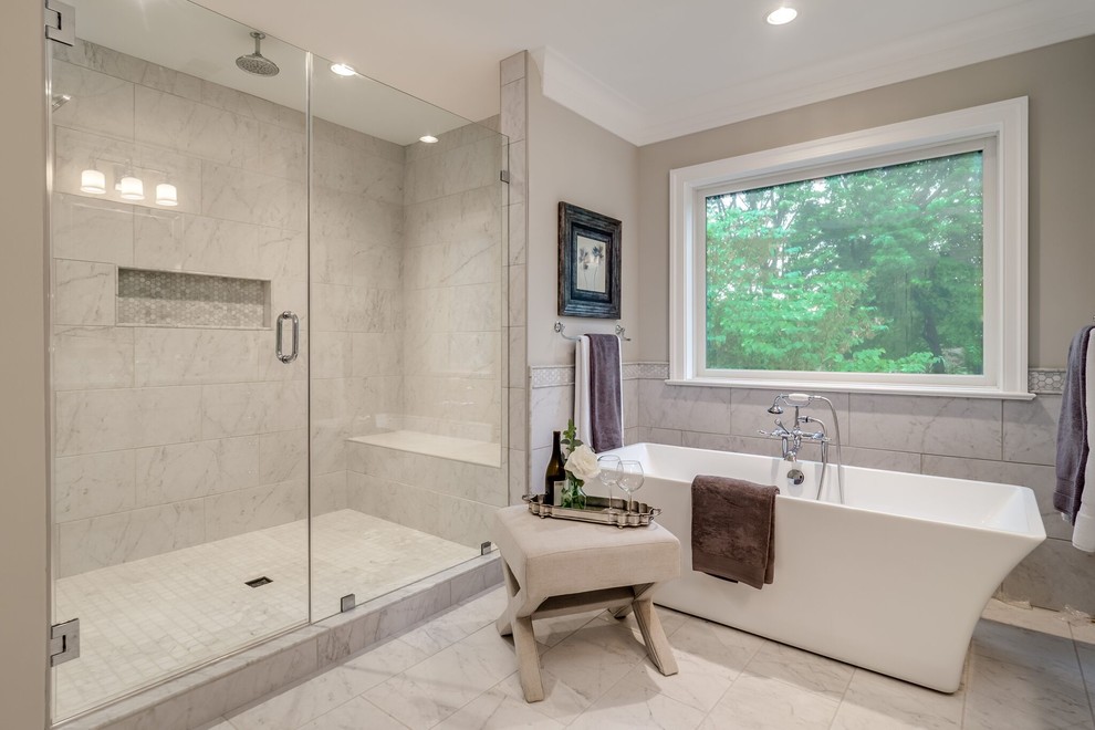Design ideas for a large arts and crafts master bathroom in DC Metro with flat-panel cabinets, white cabinets, a freestanding tub, an open shower, a one-piece toilet, white tile, porcelain tile, grey walls, porcelain floors, a drop-in sink, marble benchtops, white floor and a hinged shower door.