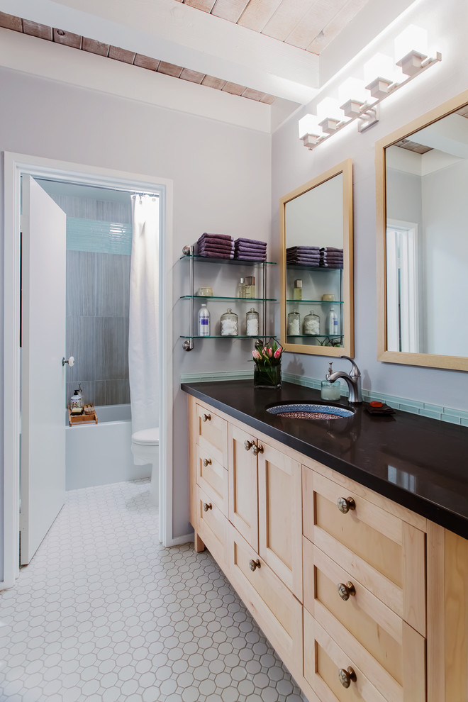 This is an example of a contemporary bathroom in San Francisco with an undermount sink, shaker cabinets, light wood cabinets, a shower/bathtub combo, blue tile and matchstick tile.