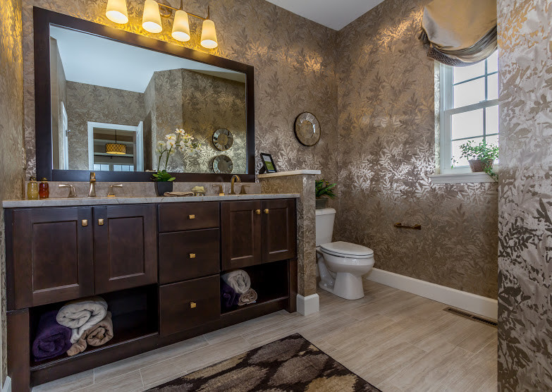 Example of a transitional master ceramic tile and beige floor bathroom design with shaker cabinets, dark wood cabinets, a one-piece toilet, beige walls, an undermount sink and quartzite countertops