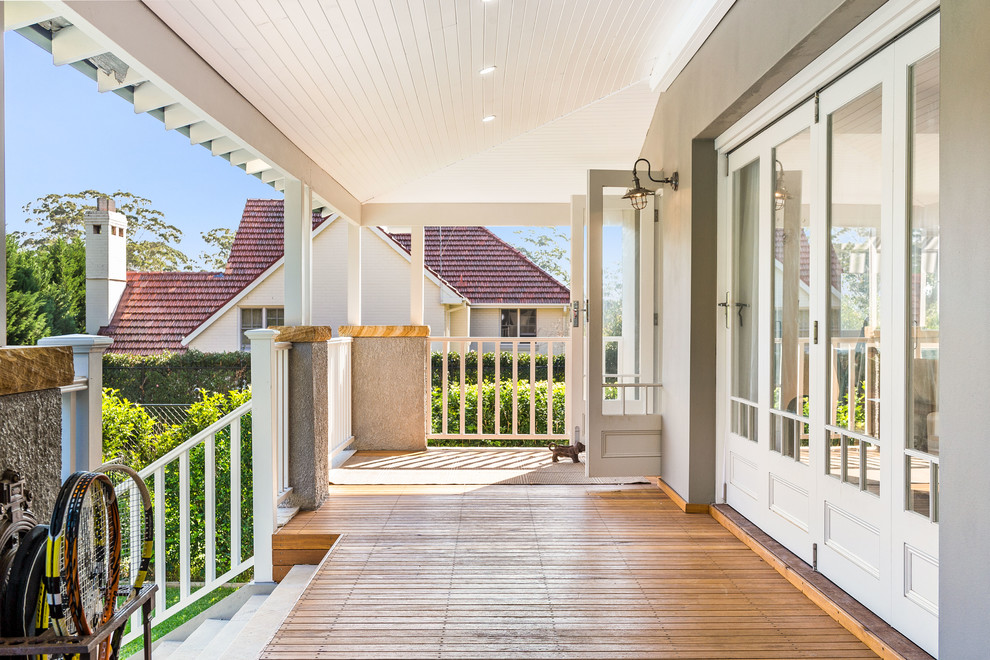 This is an example of a small transitional backyard verandah in Sydney with a roof extension.