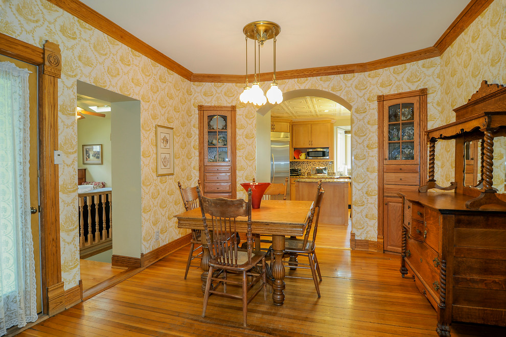 Inspiration for a traditional separate dining room in Other with multi-coloured walls and medium hardwood floors.
