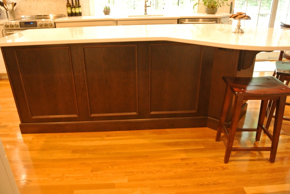 Inspiration for a transitional medium tone wood floor eat-in kitchen remodel in Boston with an undermount sink, shaker cabinets, quartz countertops, beige backsplash, mosaic tile backsplash, stainless steel appliances, an island and white countertops