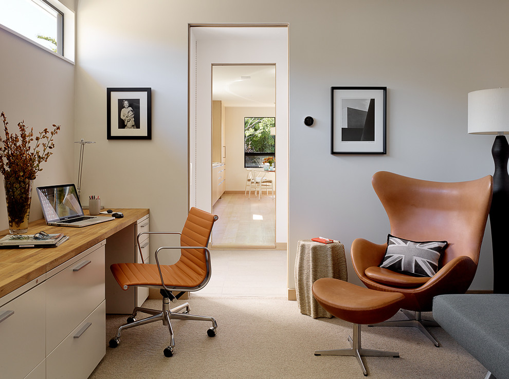 Design ideas for a midcentury study room in San Francisco with white walls, carpet, no fireplace and a built-in desk.