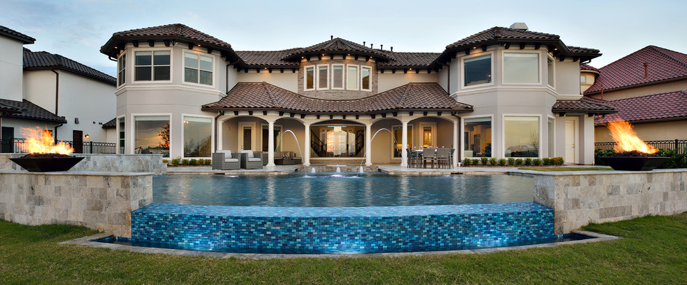 Hot tub - large transitional backyard stone and custom-shaped infinity hot tub idea in Houston