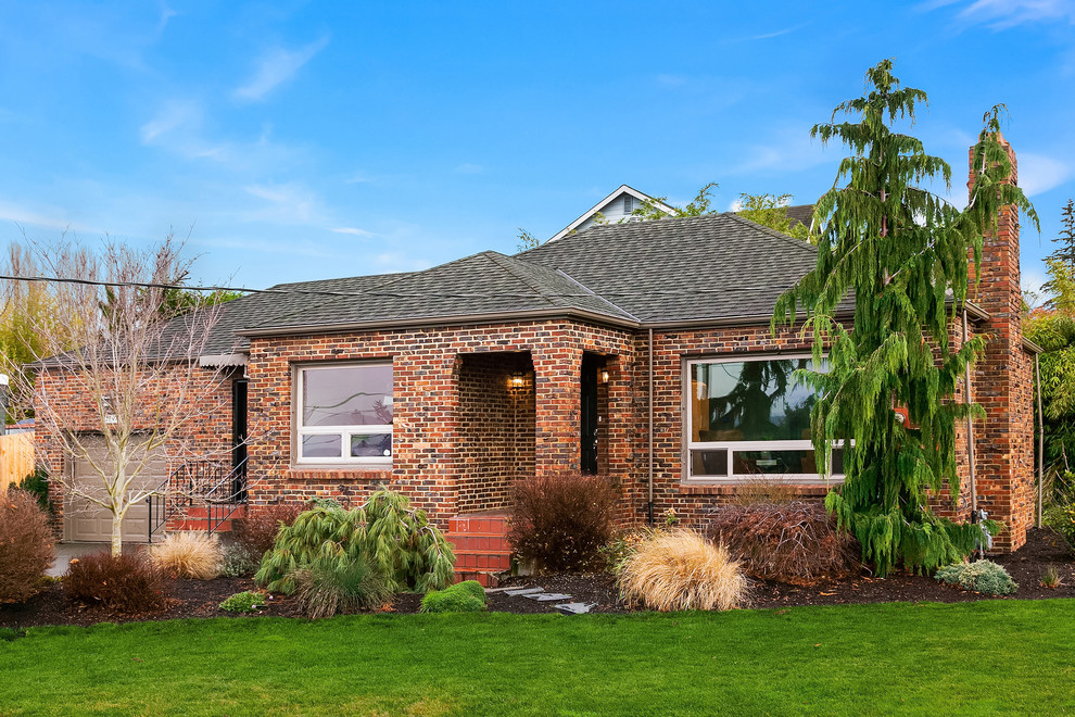 This is an example of a large traditional two-storey brick house exterior in Seattle with a gable roof.