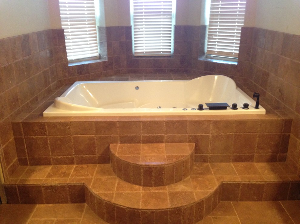 Mid-sized country master bathroom in Austin with beaded inset cabinets, dark wood cabinets, a drop-in tub, beige tile, stone tile, beige walls and travertine floors.