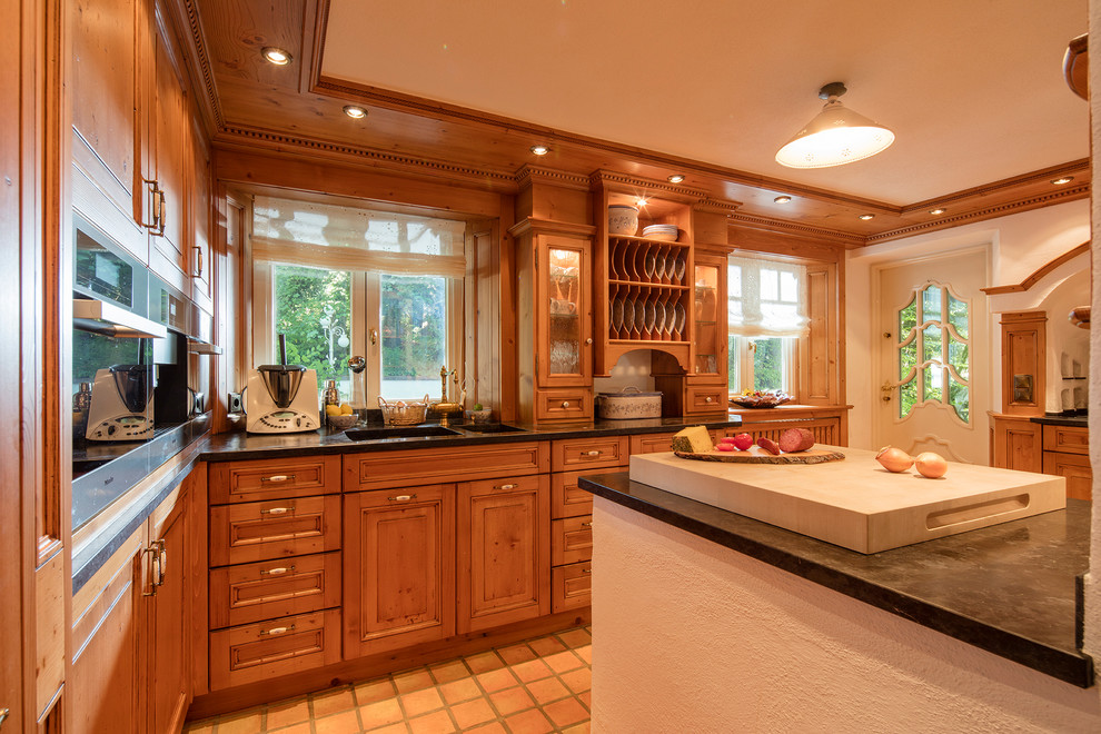 Inspiration for a mid-sized country u-shaped separate kitchen in Other with beaded inset cabinets, light wood cabinets, an integrated sink, marble benchtops, stainless steel appliances, a peninsula and terra-cotta floors.