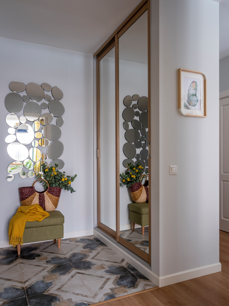 This is an example of a mid-sized beach style entryway in Moscow with grey walls, porcelain floors, a single front door, a white front door and multi-coloured floor.