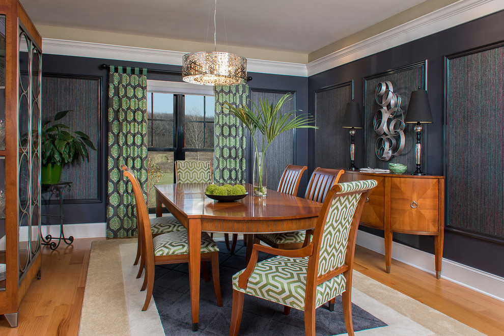 This is an example of a mid-sized contemporary separate dining room in Milwaukee with black walls, no fireplace and light hardwood floors.