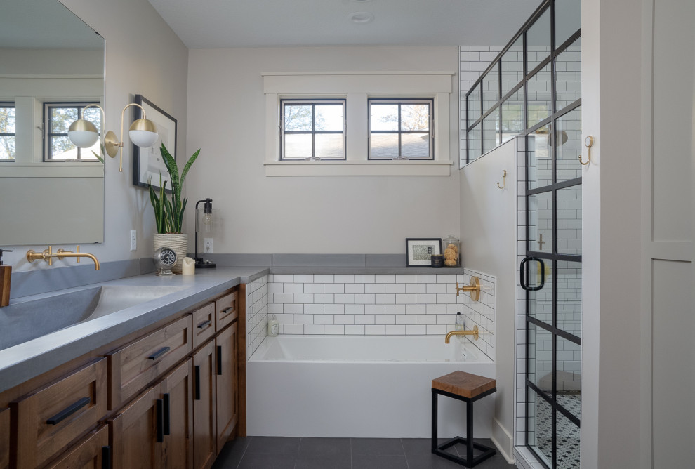 This is an example of a transitional bathroom in Other with shaker cabinets, medium wood cabinets, white tile, subway tile, grey walls, a trough sink, black floor and grey benchtops.