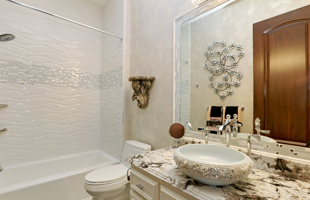 Inspiration for a mid-sized traditional 3/4 bathroom in Kansas City with raised-panel cabinets, white cabinets, an alcove tub, a shower/bathtub combo, a one-piece toilet, white tile, porcelain tile, white walls, a vessel sink and engineered quartz benchtops.