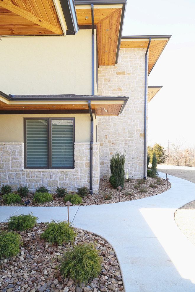 Lake House Dream - Large trendy beige two-story stone house exterior photo with a hip roof and a shingle roof