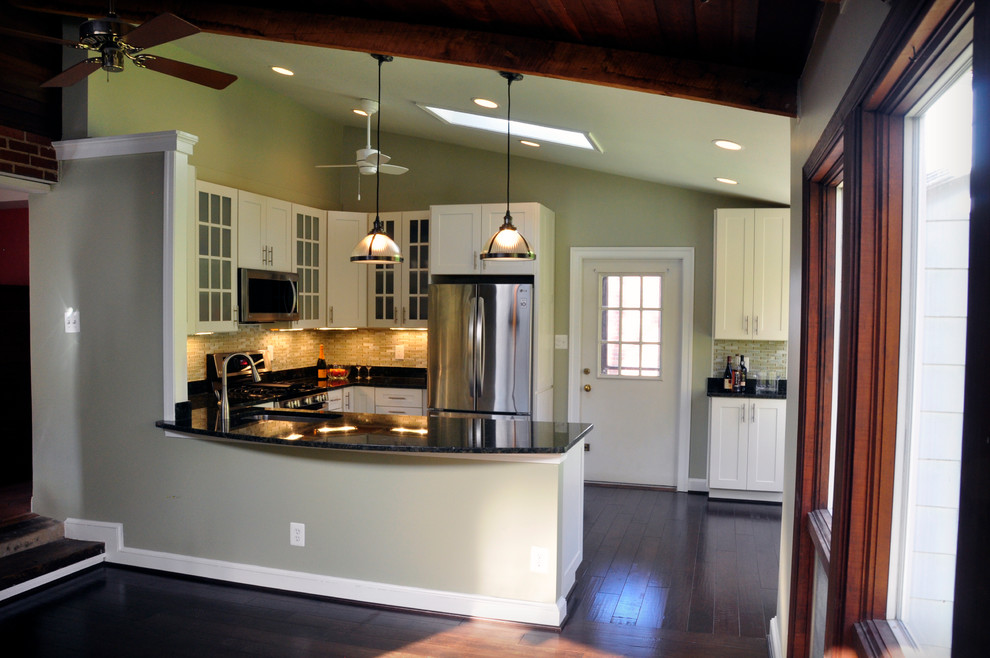 Mid-sized transitional u-shaped dark wood floor eat-in kitchen photo in DC Metro with an undermount sink, white cabinets, granite countertops, yellow backsplash, glass tile backsplash, stainless steel appliances, a peninsula and shaker cabinets