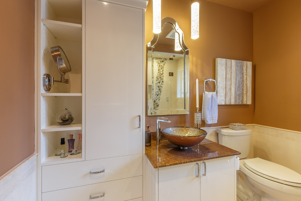 Mid-sized contemporary master bathroom in Vancouver with a vessel sink, flat-panel cabinets, white cabinets, glass benchtops, an alcove shower, a two-piece toilet, beige tile, porcelain tile, brown walls and porcelain floors.