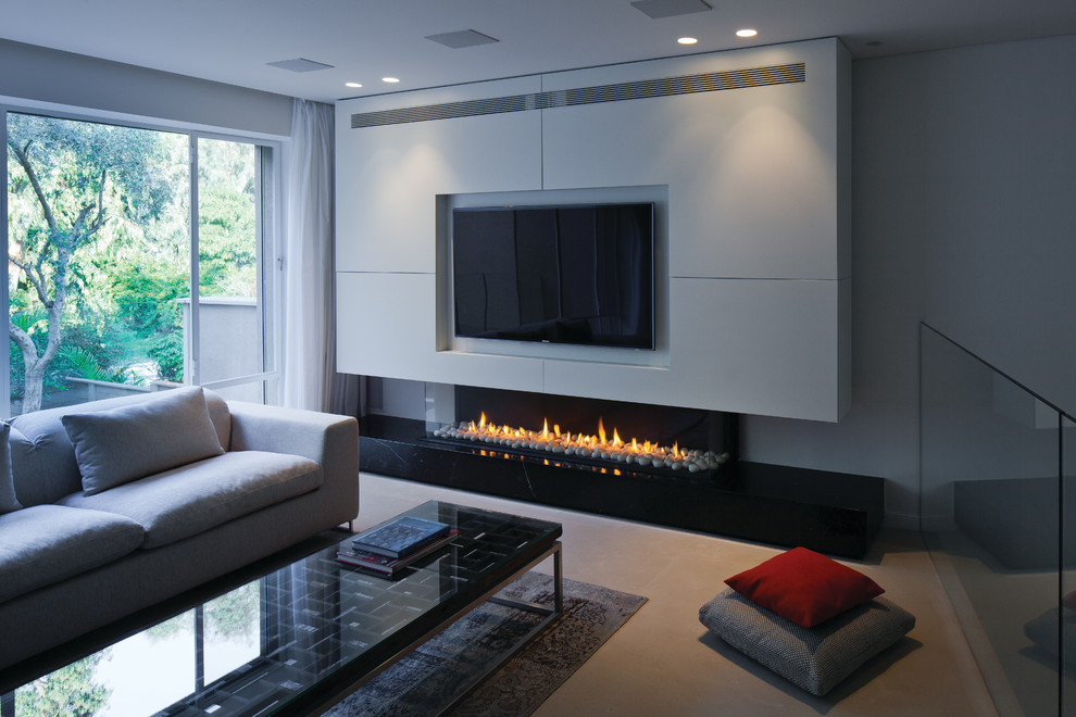 Photo of a modern living room in San Francisco with white walls, a ribbon fireplace, beige floor and a wall-mounted tv.