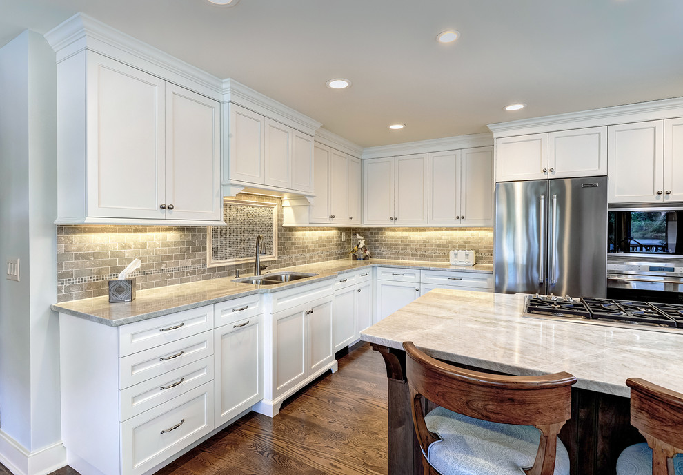 Photo of a large traditional u-shaped eat-in kitchen in Charleston with with island, recessed-panel cabinets, white cabinets and granite benchtops.