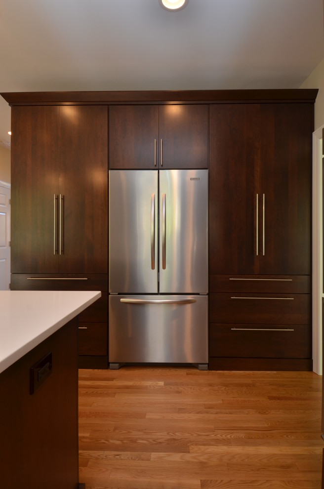 Example of a mid-sized transitional l-shaped light wood floor eat-in kitchen design in Chicago with an undermount sink, flat-panel cabinets, dark wood cabinets, quartzite countertops, multicolored backsplash, matchstick tile backsplash, stainless steel appliances and an island