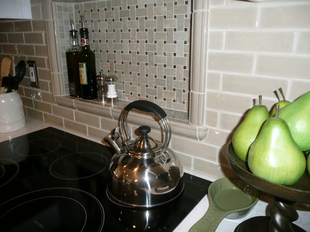 Example of a mid-sized transitional l-shaped eat-in kitchen design with quartz countertops, beige backsplash, subway tile backsplash, stainless steel appliances and white countertops