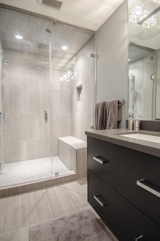 Mid-sized contemporary 3/4 bathroom in Vancouver with flat-panel cabinets, black cabinets, an alcove shower, a two-piece toilet, gray tile, ceramic tile, grey walls, ceramic floors and an undermount sink.