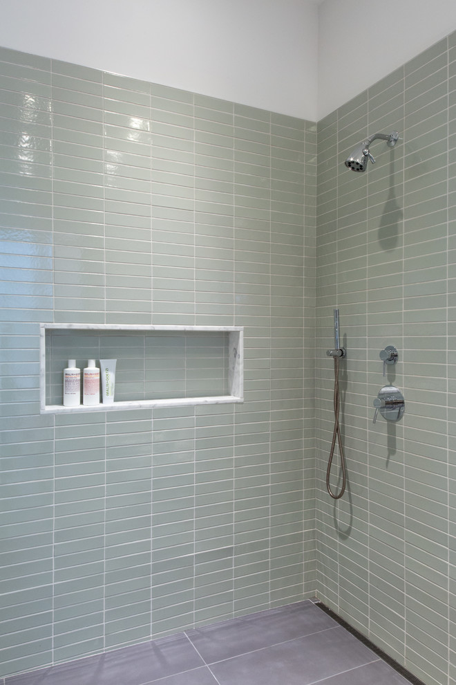 Photo of an industrial bathroom in New York with a freestanding tub, a corner shower, green tile, ceramic tile, white walls, concrete floors and grey floor.