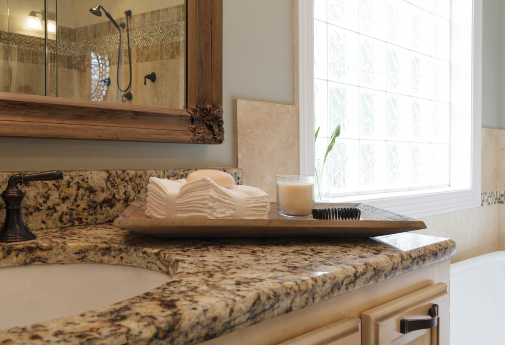 Design ideas for a large traditional master bathroom in Nashville with raised-panel cabinets, beige cabinets, a drop-in tub, a double shower, a two-piece toilet, beige tile, stone tile, blue walls, an undermount sink and granite benchtops.