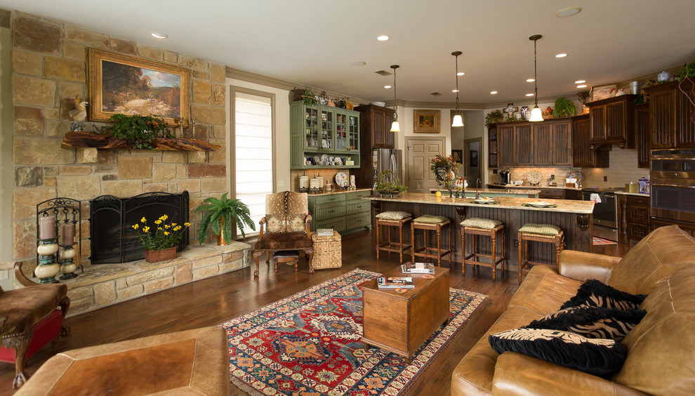 Example of a mid-sized mountain style u-shaped brown floor and dark wood floor eat-in kitchen design in Austin with a farmhouse sink, beaded inset cabinets, medium tone wood cabinets, granite countertops, beige backsplash, ceramic backsplash, stainless steel appliances, two islands and multicolored countertops