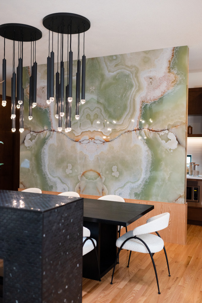 Imagen de comedor de cocina abovedado retro grande con paredes verdes, suelo de madera en tonos medios, chimenea de doble cara, marco de chimenea de piedra y suelo naranja