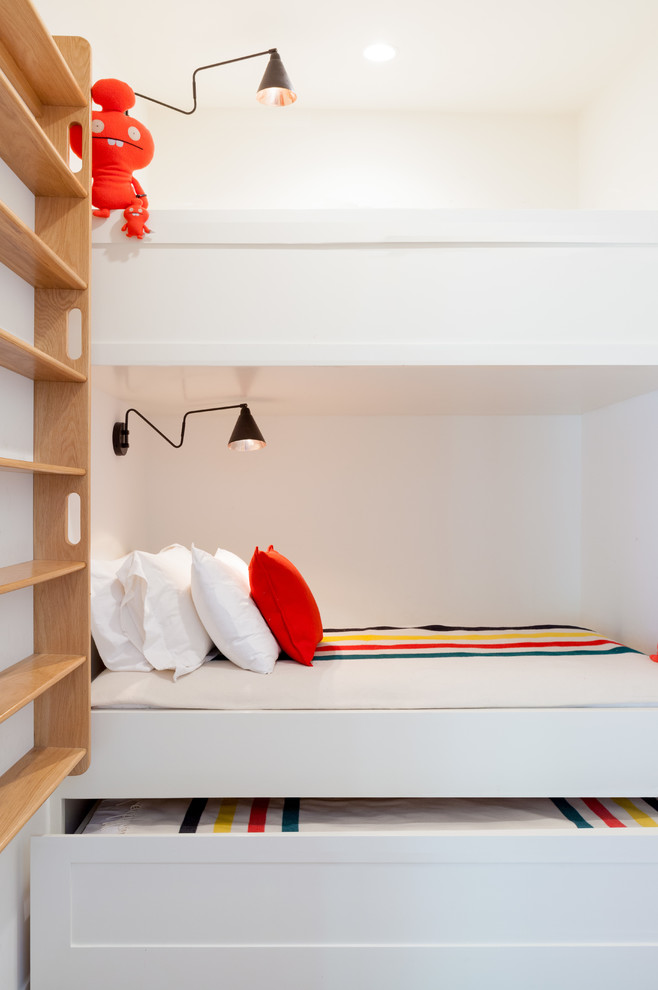 Design ideas for a contemporary kids' bedroom for boys in Los Angeles with white walls and white floor.