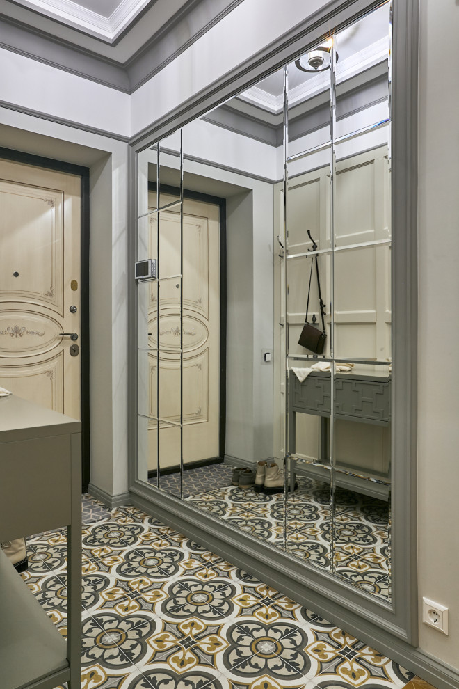 This is an example of a mid-sized traditional vestibule in Moscow with grey walls, ceramic floors, a single front door, multi-coloured floor and coffered.