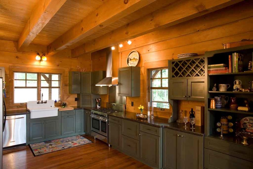 Inspiration for a mid-sized country l-shaped open plan kitchen in Charlotte with a drop-in sink, recessed-panel cabinets, green cabinets, granite benchtops, black splashback, stainless steel appliances, medium hardwood floors and no island.