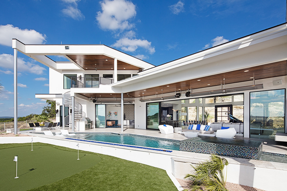 Photo of a beach style two-storey white house exterior in Austin with a flat roof.