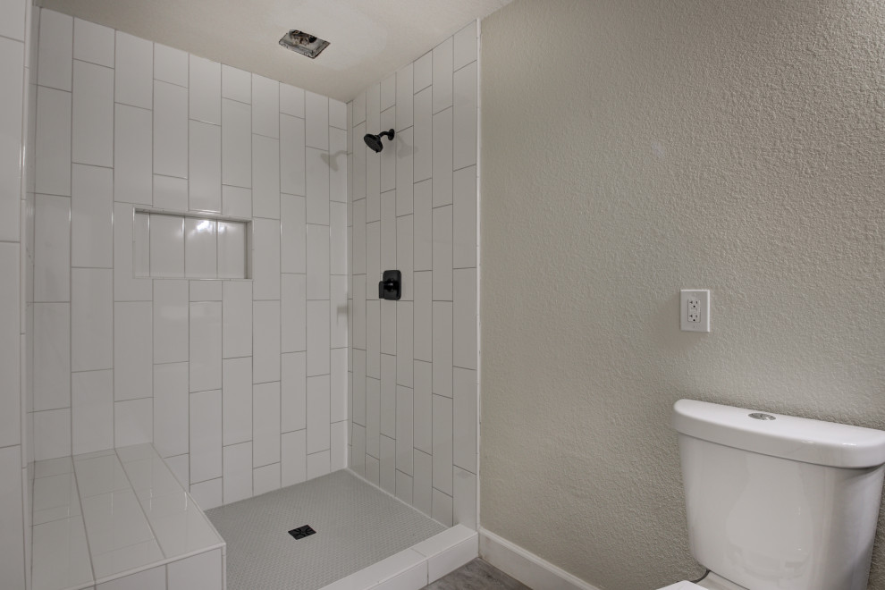 Example of a mid-sized transitional master white tile and subway tile double-sink freestanding bathtub design in Phoenix with shaker cabinets, brown cabinets, an undermount sink, quartz countertops, white countertops and a built-in vanity