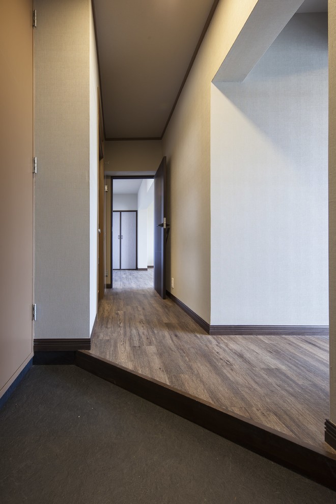 Design ideas for a mid-sized asian hallway in Other with grey walls, brown floor, wallpaper and wallpaper.