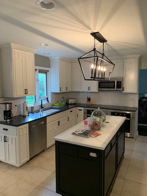 Transitional kitchen photo in Chicago with quartz countertops, an island and black countertops