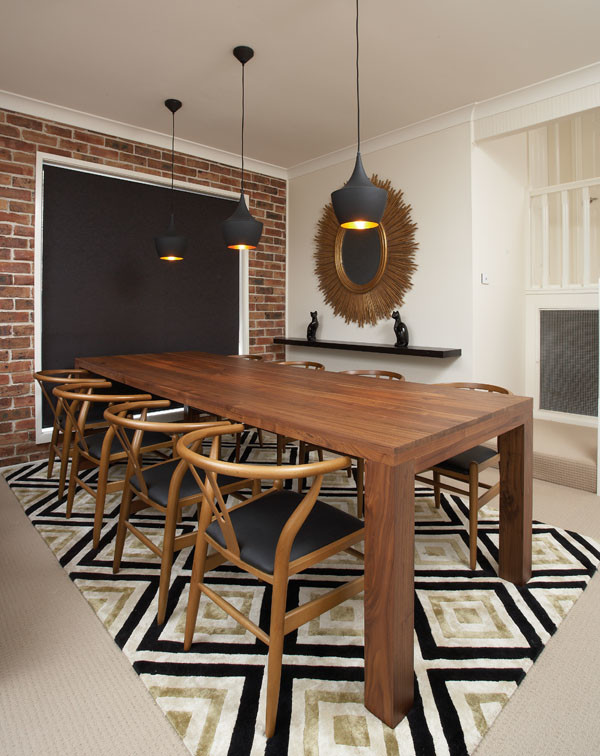 This is an example of a mid-sized midcentury separate dining room in Sydney with white walls, carpet and no fireplace.
